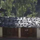 The roof being held down with boards and rocks