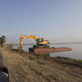 Floating Excavator for cleaning the lake.